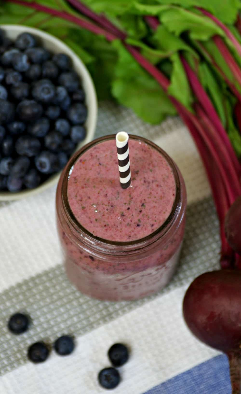 overhead photo of mason jar filled with Blueberry, Beet and Spinach Smoothie