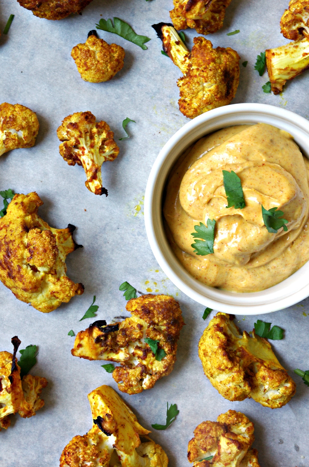 scattered Curried Oven Roasted Cauliflower with side dish of Curry Mayo