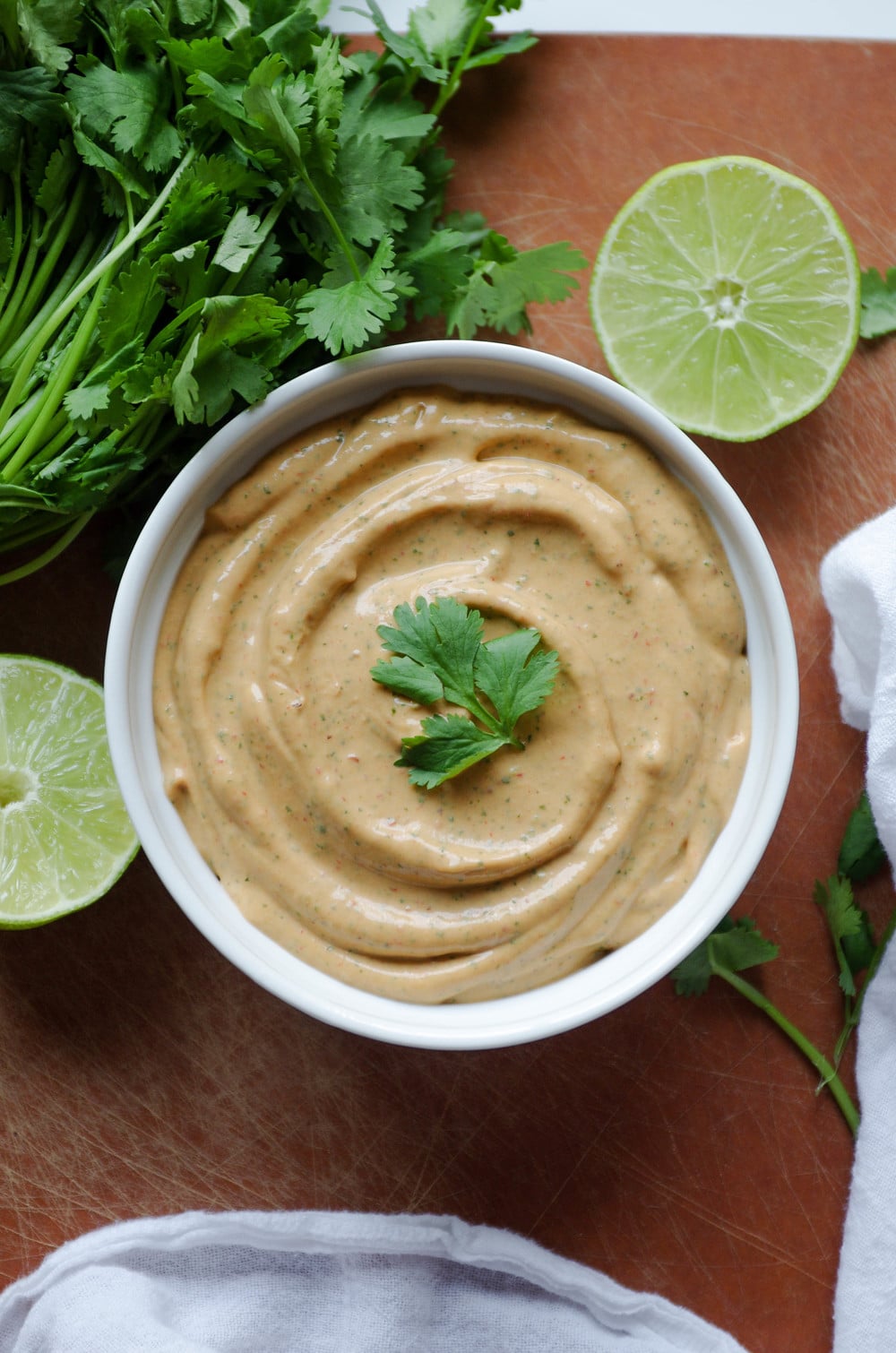 Chipotle Lime Crema in white bowl with limes cilantro 