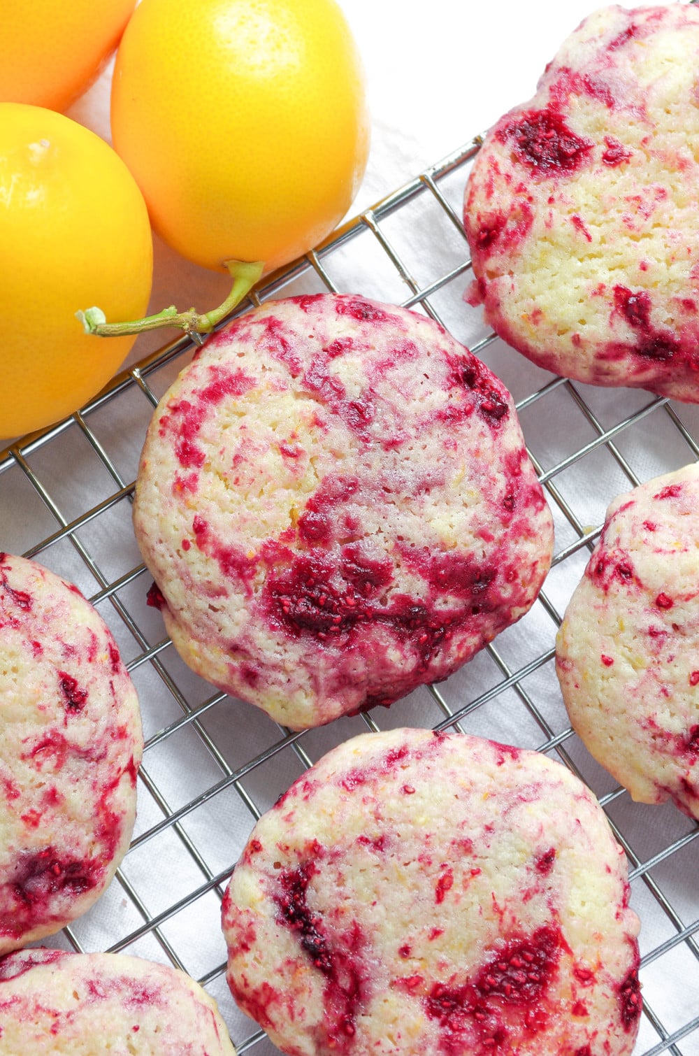 Cookies made with raspberries and lemon cooking on a cooking rack