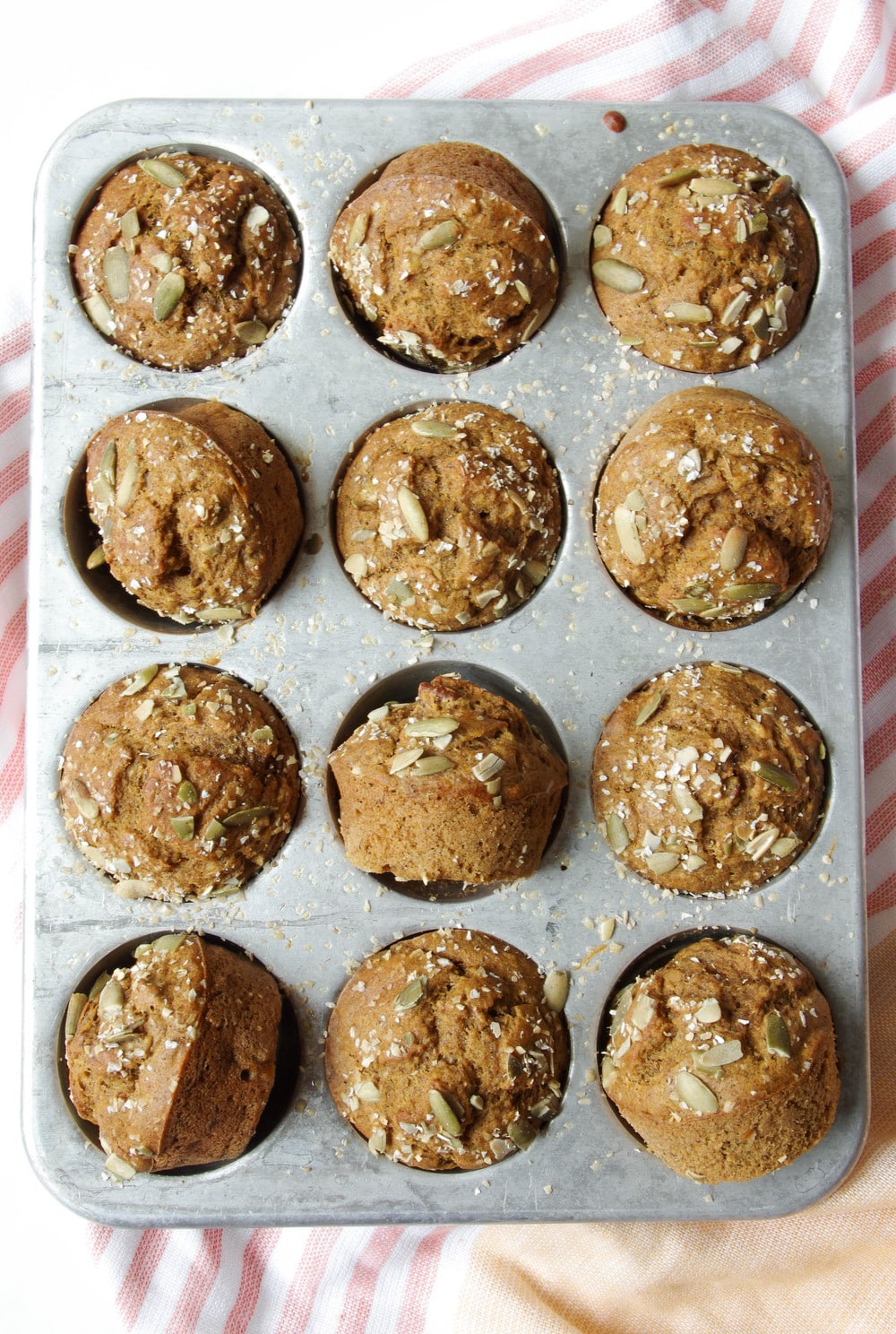 muffin pan filled with 12 Pumpkin Banana Muffins