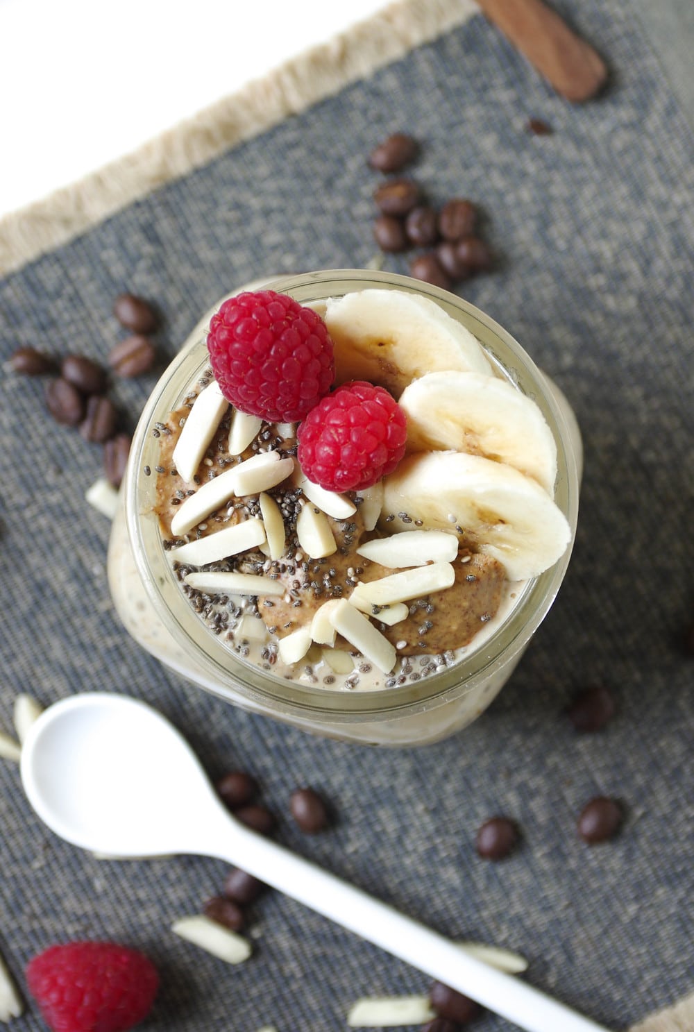 overhead close up of Espresso Overnight Oats covered in raspberries and banana