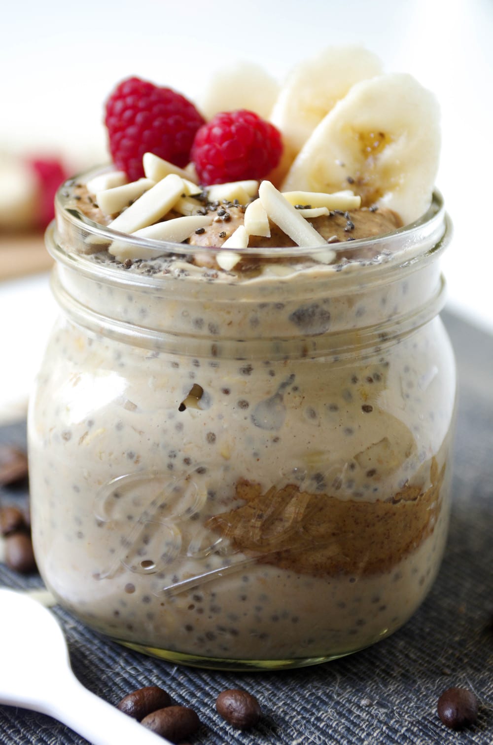 close up of Espresso Overnight Oats covered in raspberries and banana