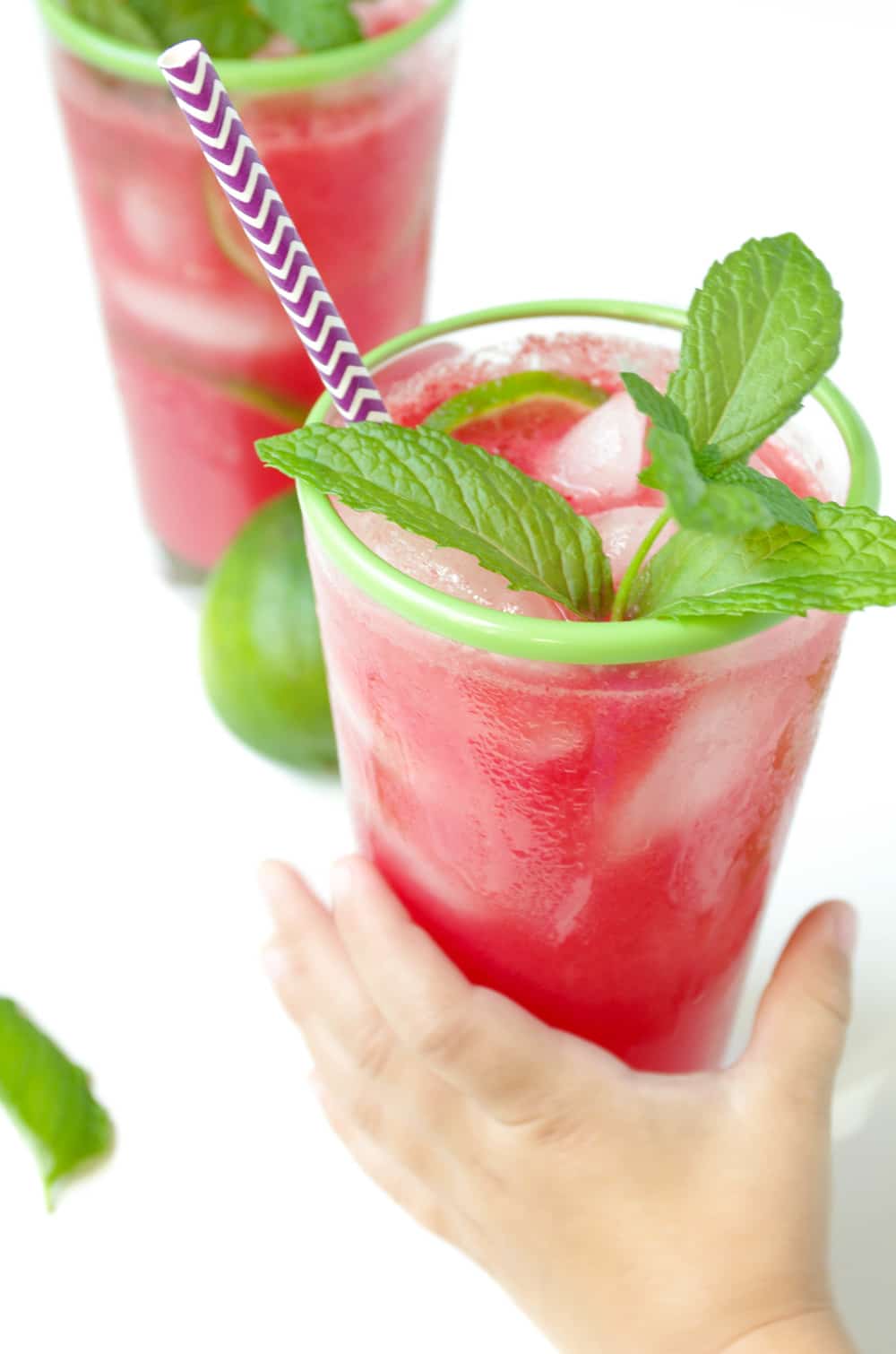 child hand grabbing glass of Watermelon Limeade