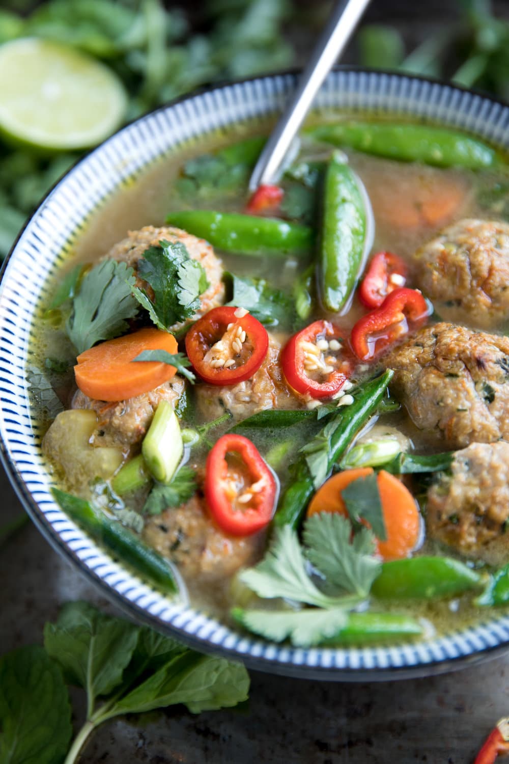 Healthy Thai Veggie Soup with Spicy Thai Meatballs in blue bowl