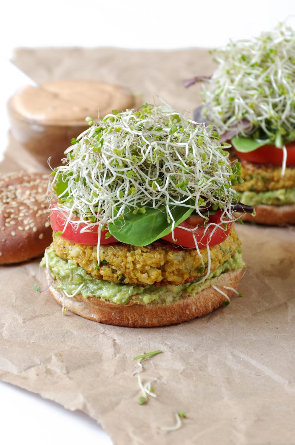 open face Easy Cauliflower Veggie Burgers with Avocado and Chipotle Mayo on brown paper