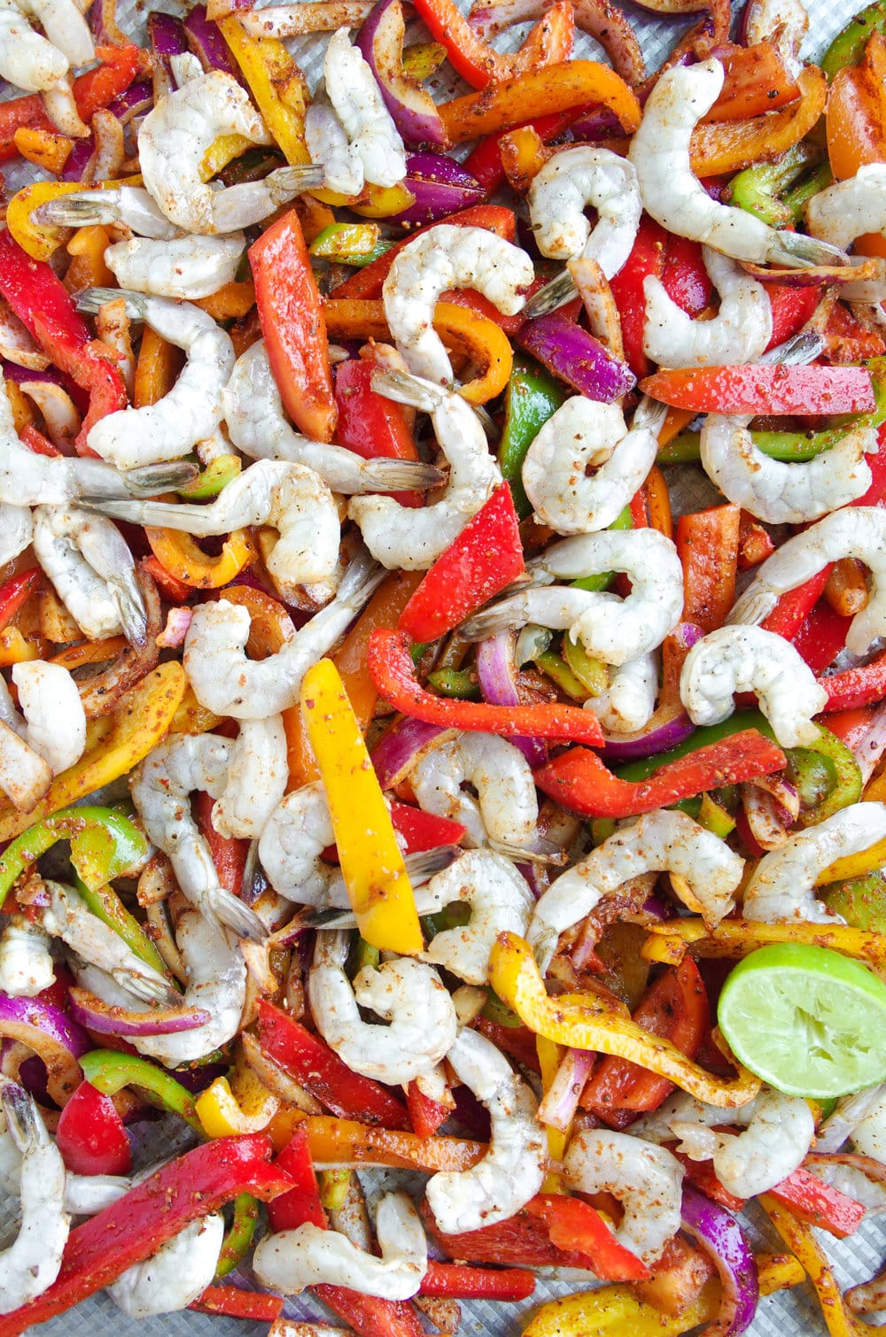 Sheet Pan covered in Shrimp onions and bell peppers raw