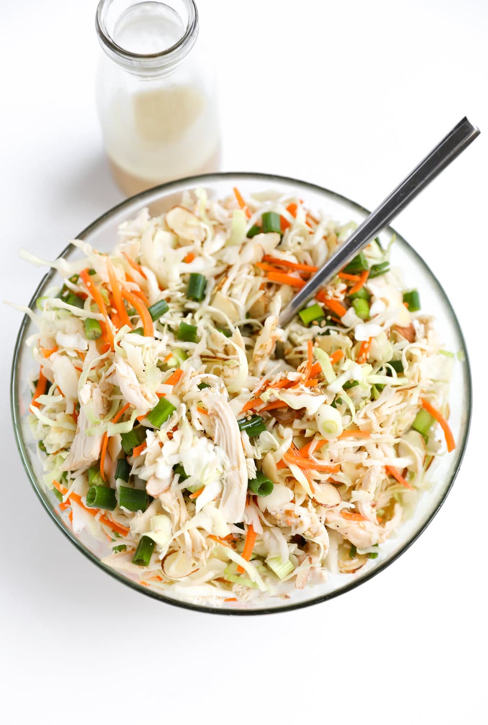 glass bowl full of Chicken Cabbage Salad with Light Sesame Vinaigrette in jar