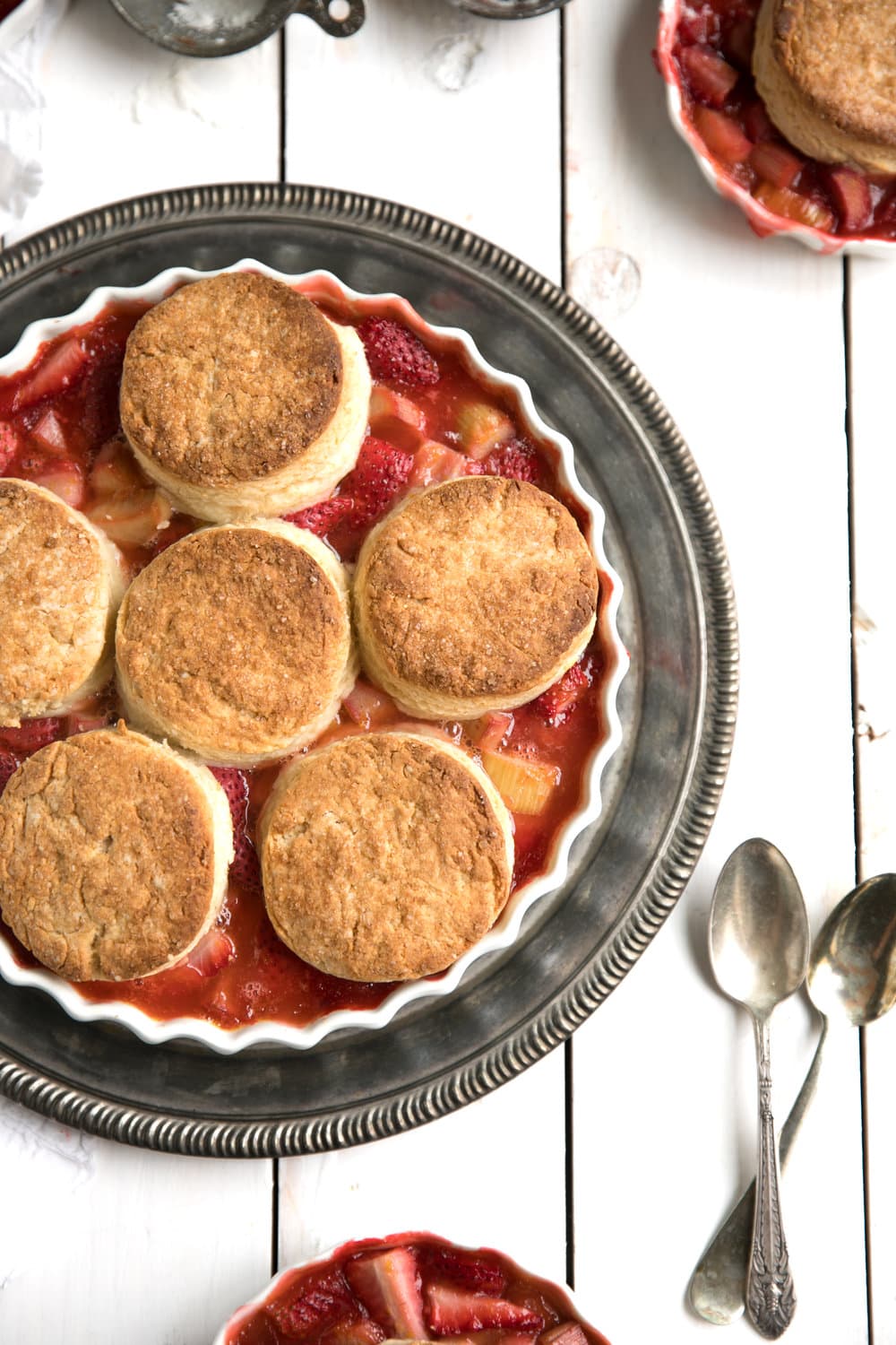 The perfect balance of sweet strawberries and sour rhubarb topped with easy homemade honey butter biscuits in this springtime favorite Strawberry Rhubarb Cobbler.